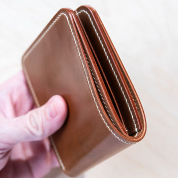 The side of a bourbon leather wallet.